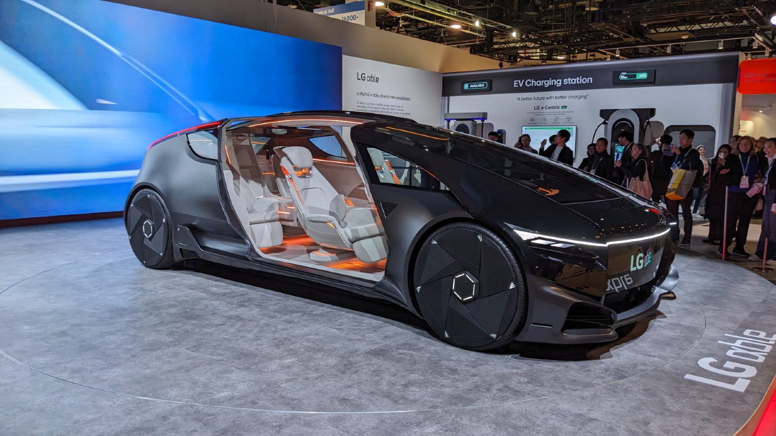 A futuristic car is on display at an auto show.