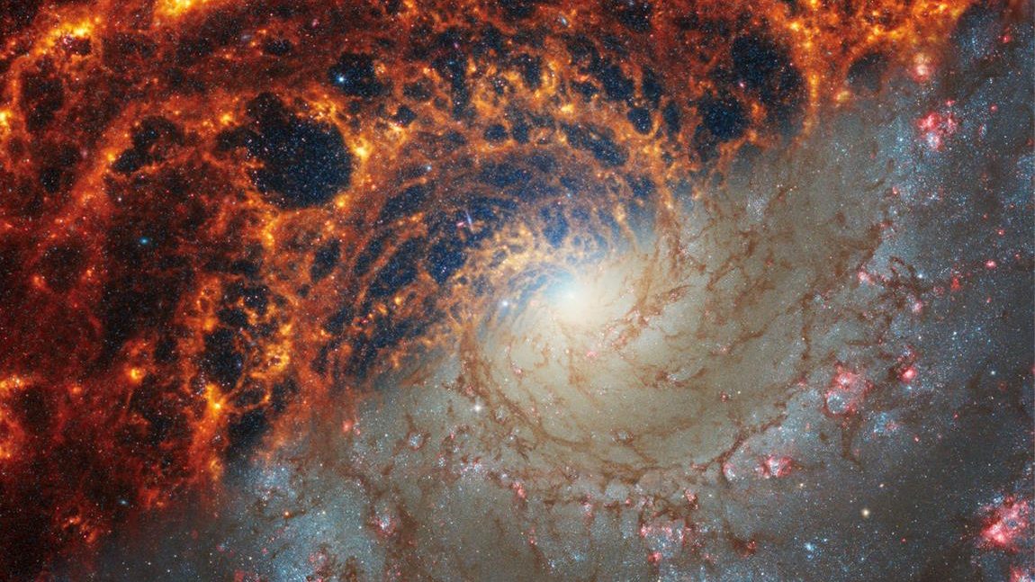 An image of a spiral galaxy taken by the JWST in space.