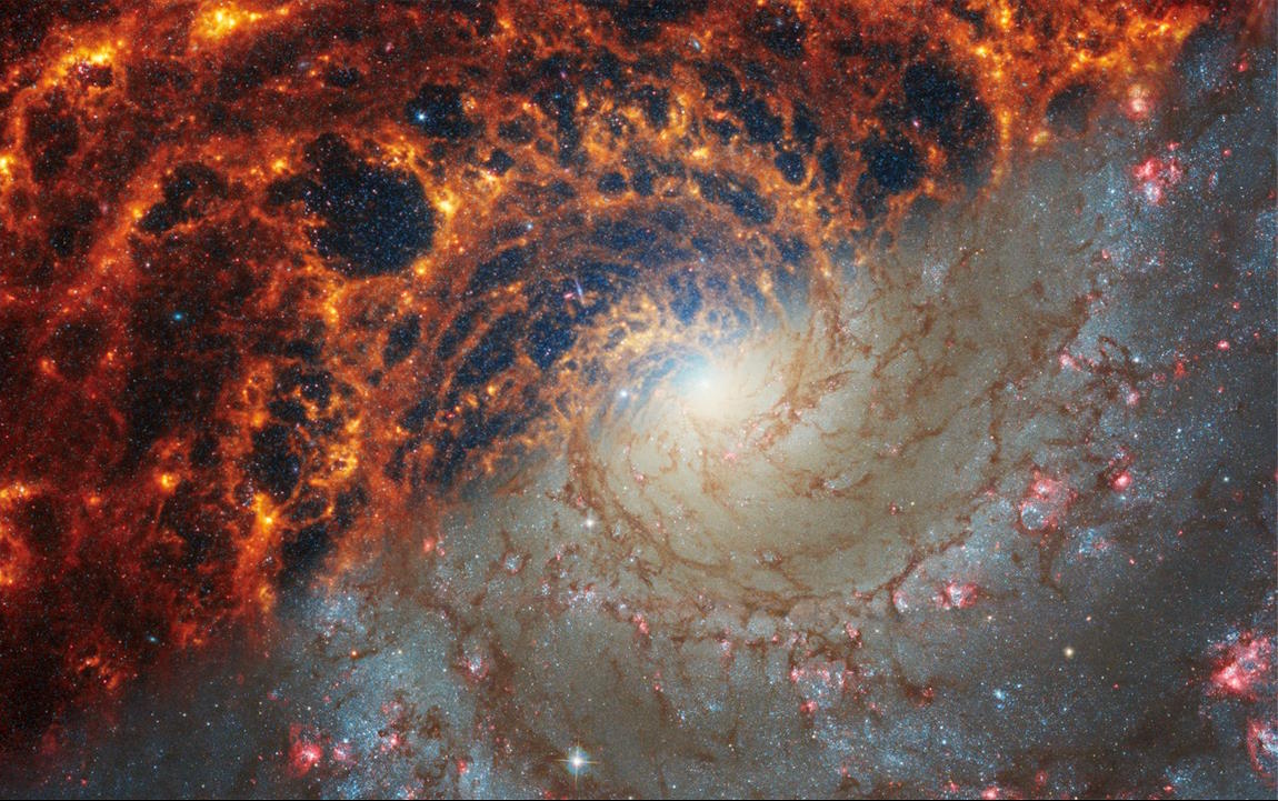 An image of a spiral galaxy taken by the JWST in space.