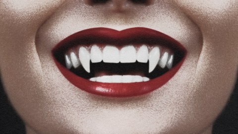 Smiling vampire showing fangs.