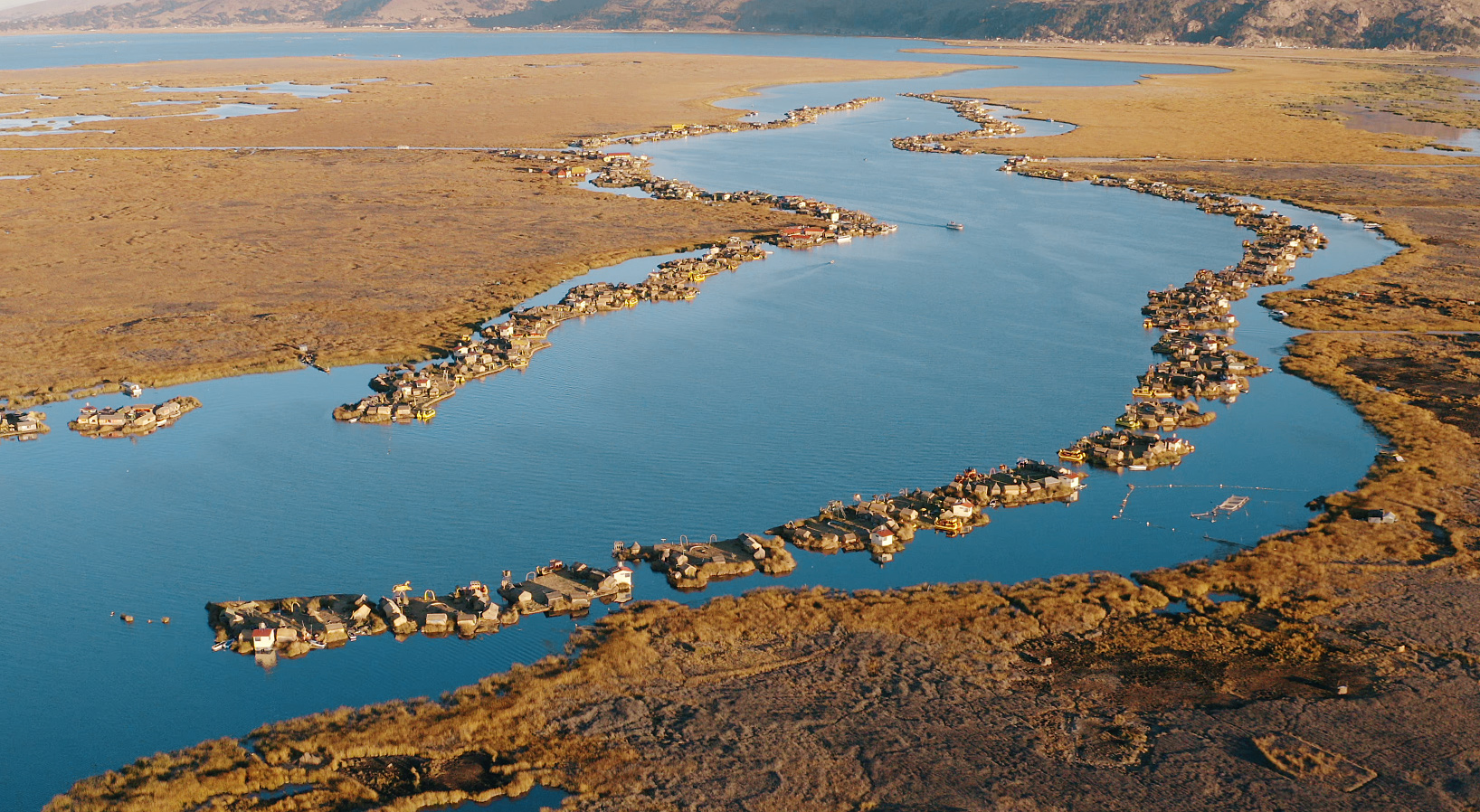 An aerial view of a large body of water dotted with Uros islands.