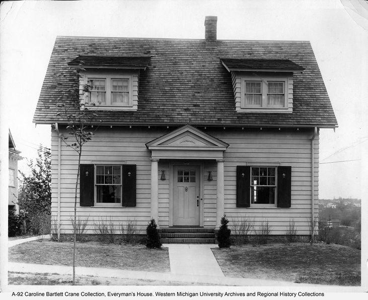 A black and white photo of a small house.