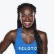 A woman wearing a blue tank top with the word peloto on it.