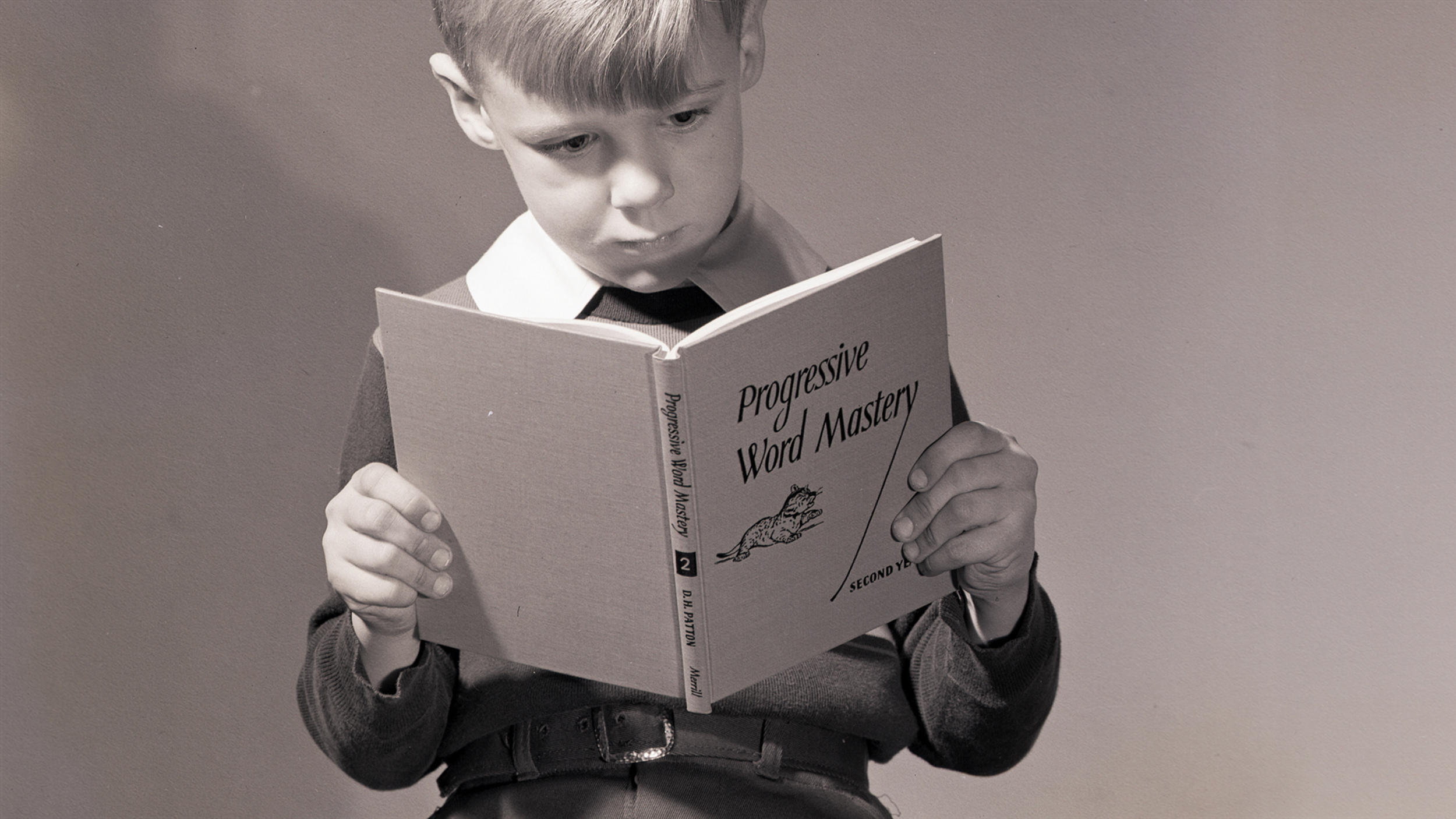 A gifted young boy reading a book.