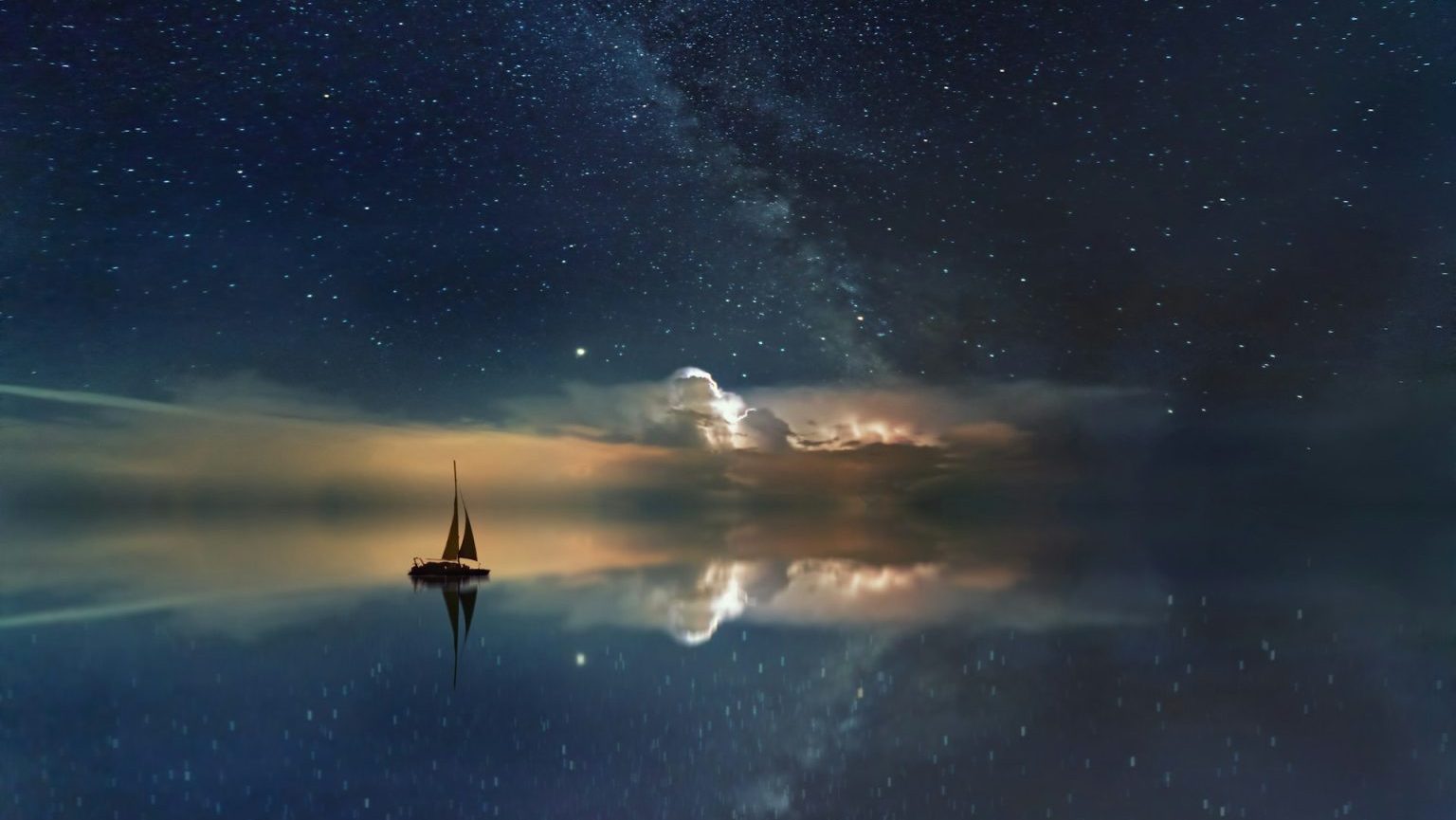 A sailboat on calm waters under a starry night sky with reflections on the surface.