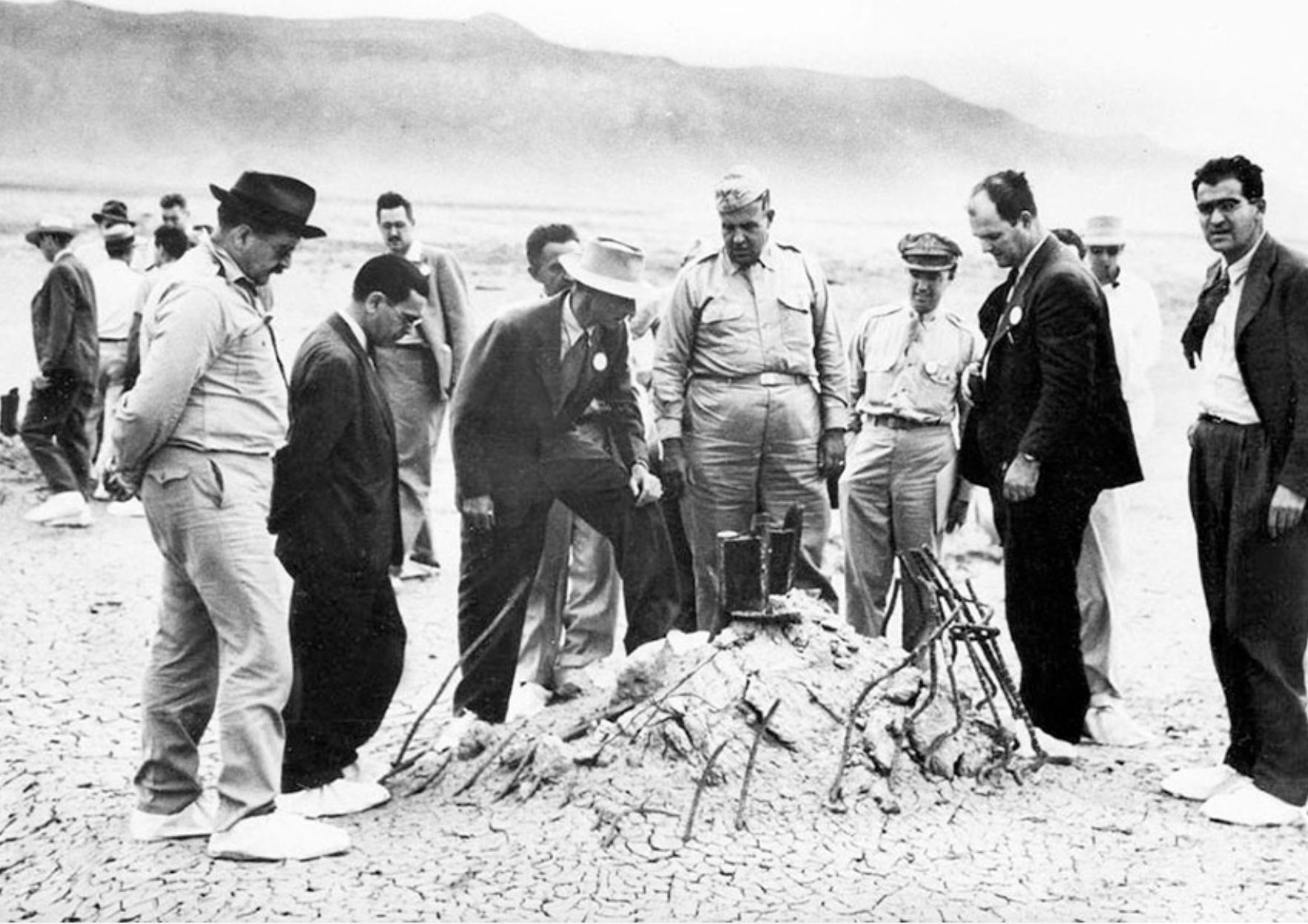 Group of men looking at a pile of rubble on the ground.