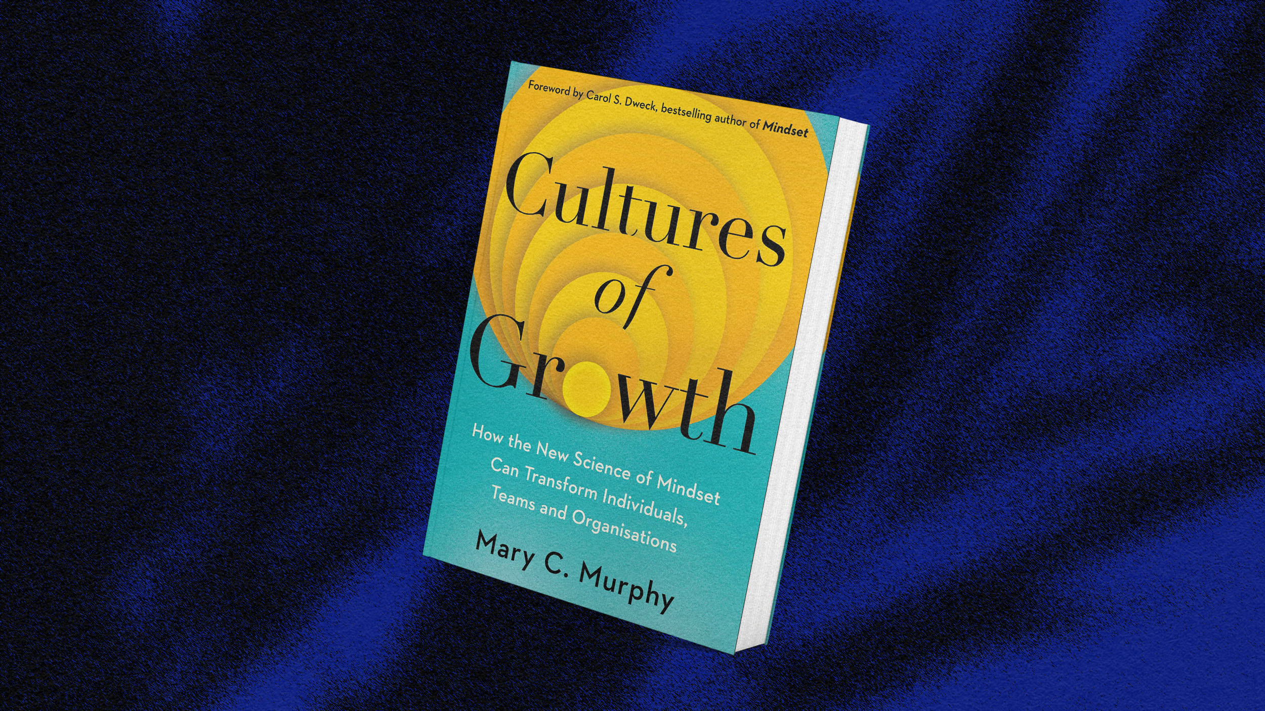 A book titled "Cultures of Growth" by Mary C. Murphy lying on a dark blue fabric surface.
