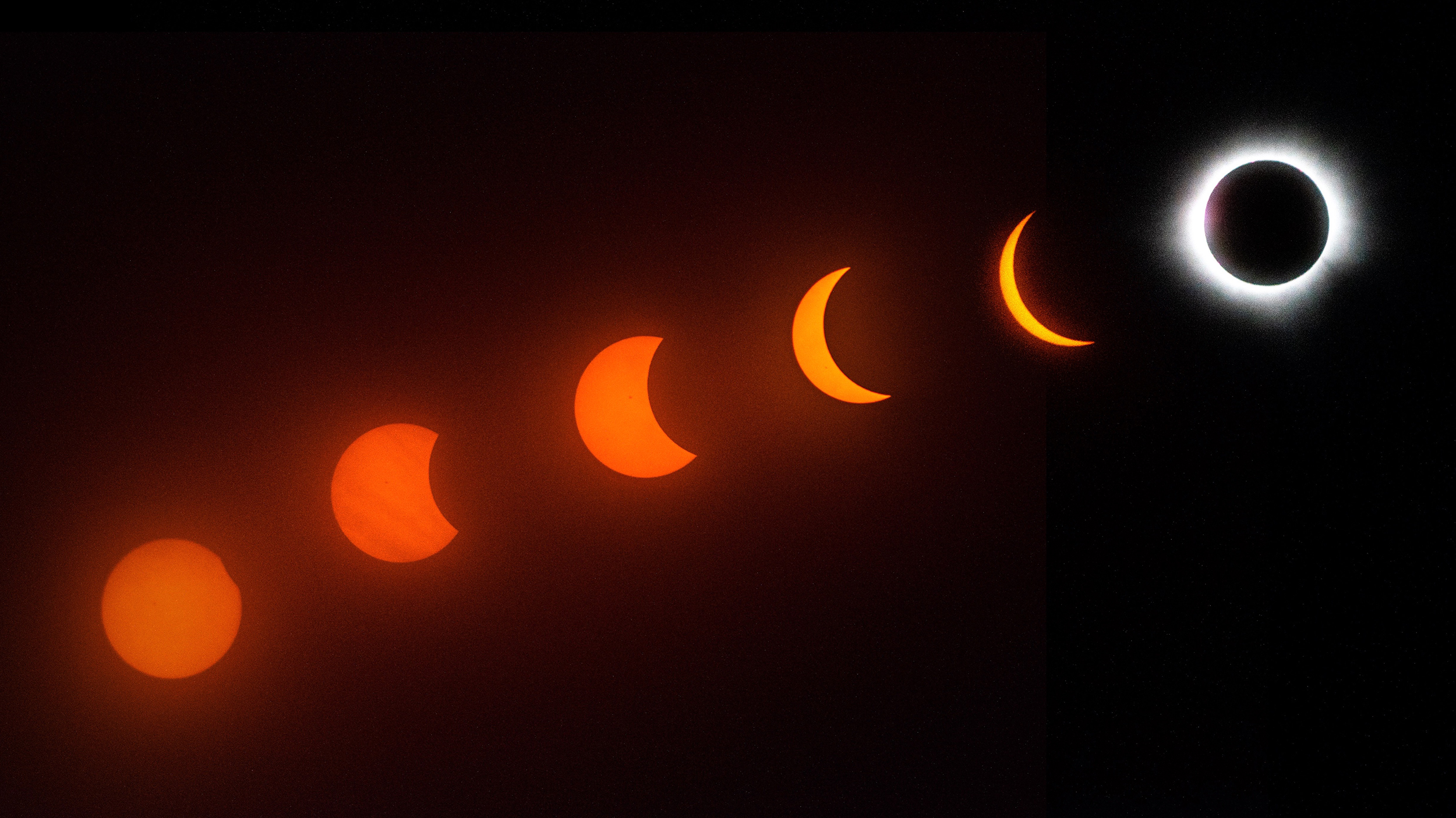 A sequence showing the phases of a solar eclipse, culminating in totality, against a dark background.