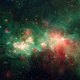 A vibrant space image showing a star-forming region with clusters of bright stars and colorful nebulas in shades of red and green.