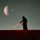 A person in a dark robe wielding a glowing red lightsaber on a desert dune under a night sky with a large crescent moon and a visible planet.