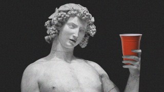 A statue of an authentic marble figure holding a red plastic cup against a black background.