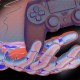 A stylized digital illustration of a hand reaching for a floating video game controller with dynamic blue and red lighting effects.