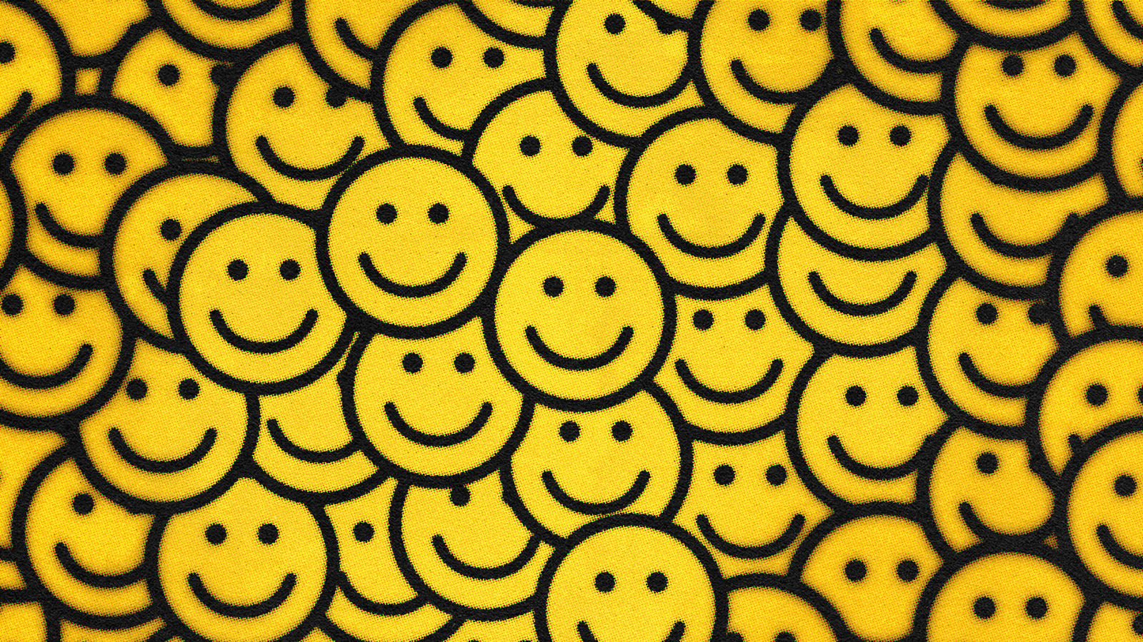 A pattern of numerous yellow smiley faces.