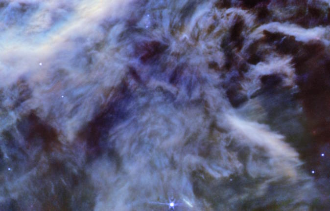 A detailed image of the Horsehead Nebula, featuring swirling clouds of purple and blue gas interspersed with bright stars.