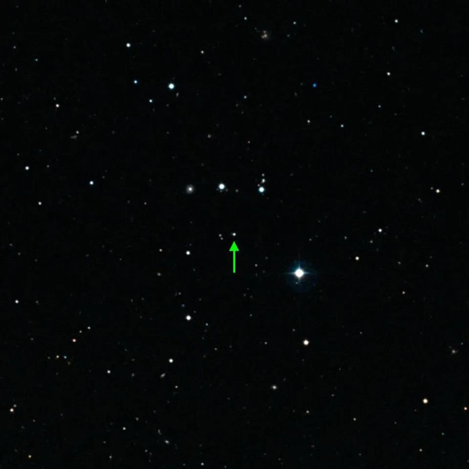 A field of stars in space with a green arrow pointing to the Methuselah star in the center.