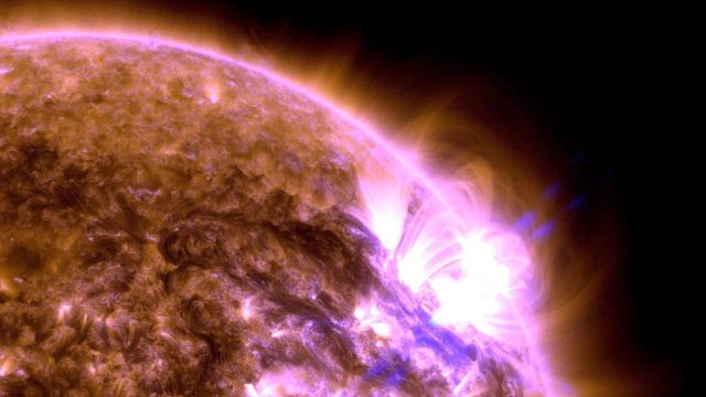 A vibrant solar flare erupts from the Sun's surface, showcasing sun activity in 2024 and emitting bright ultraviolet light in this detailed astrophotograph.