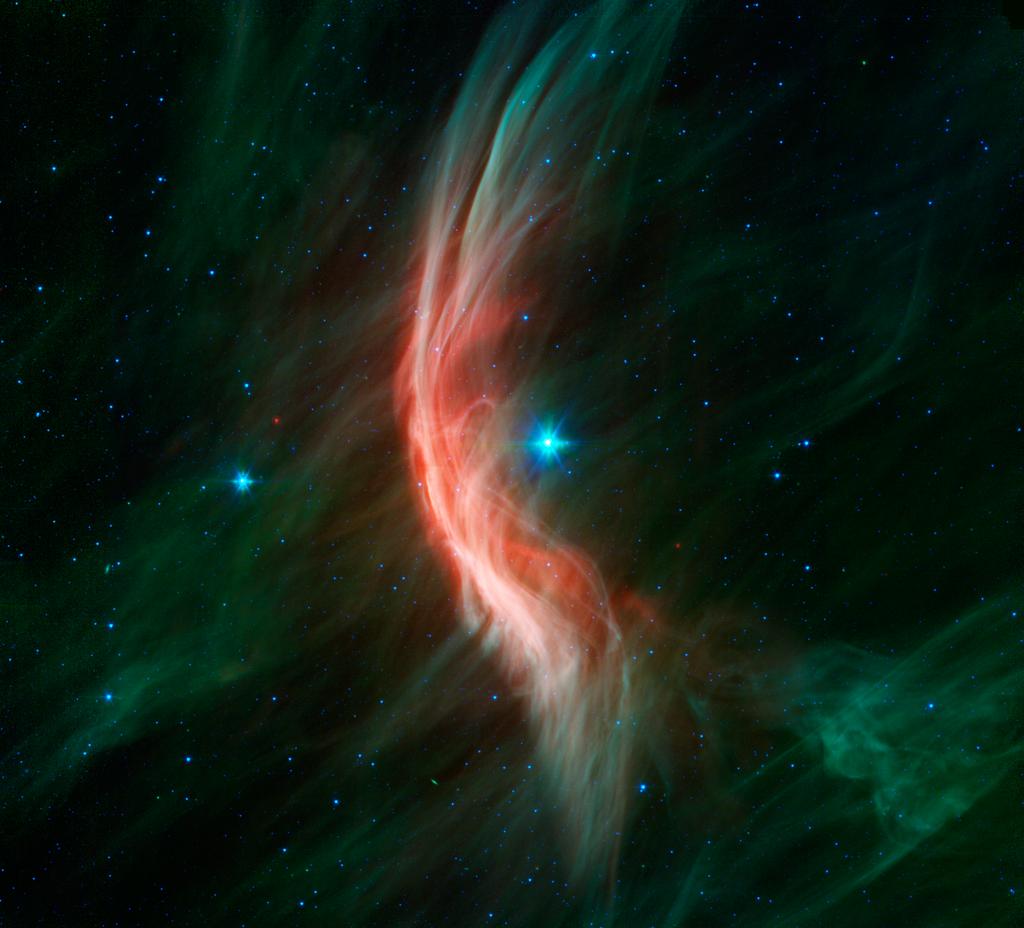 Image of the Zeta Ophiuchi star captured by NASA's Spitzer Space Telescope, showing a red and green nebula with the bright star at its center.