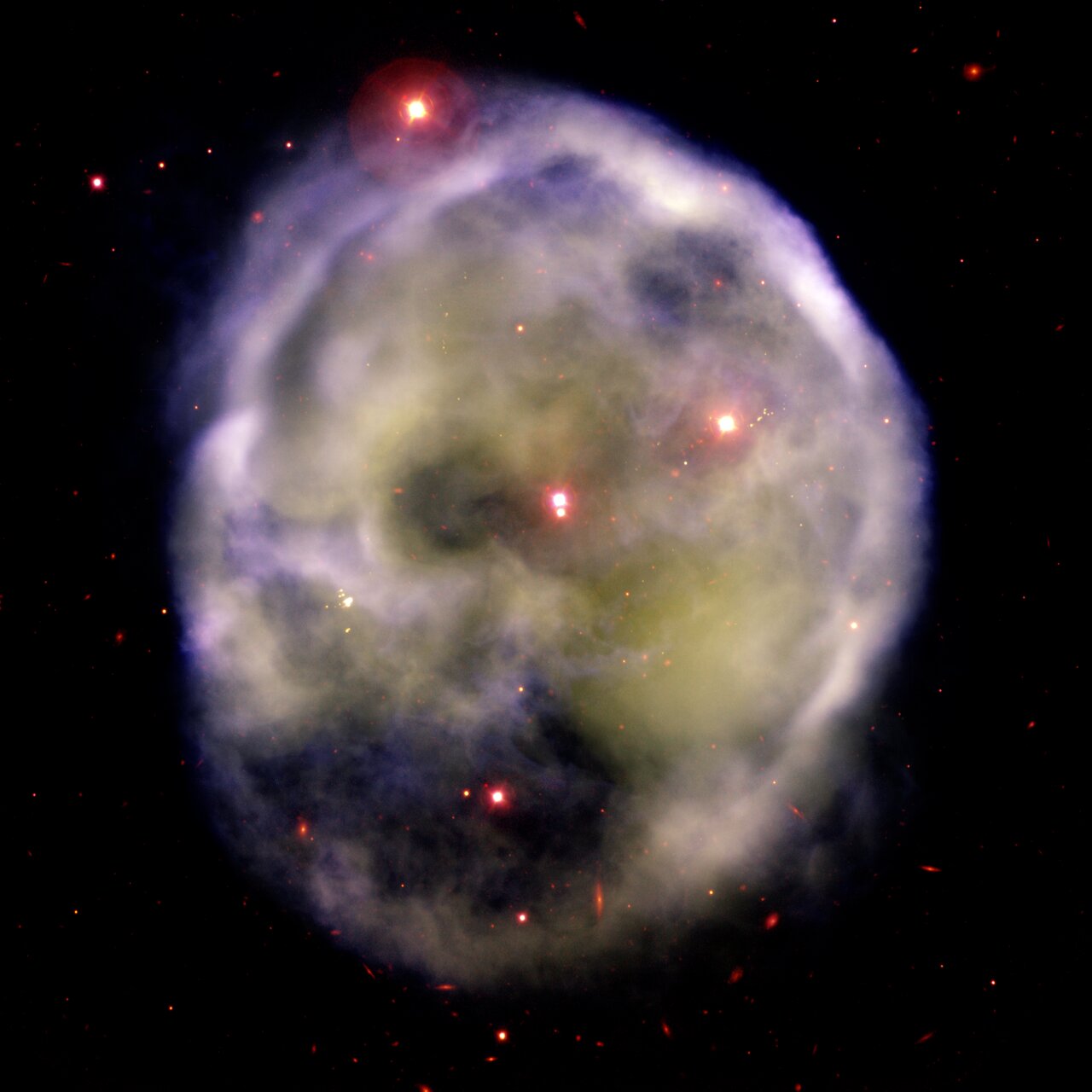 A glowing nebula with a spherical shape and several bright stars scattered throughout, set against a dark space background, reveals its intricate details through optical interferometry.