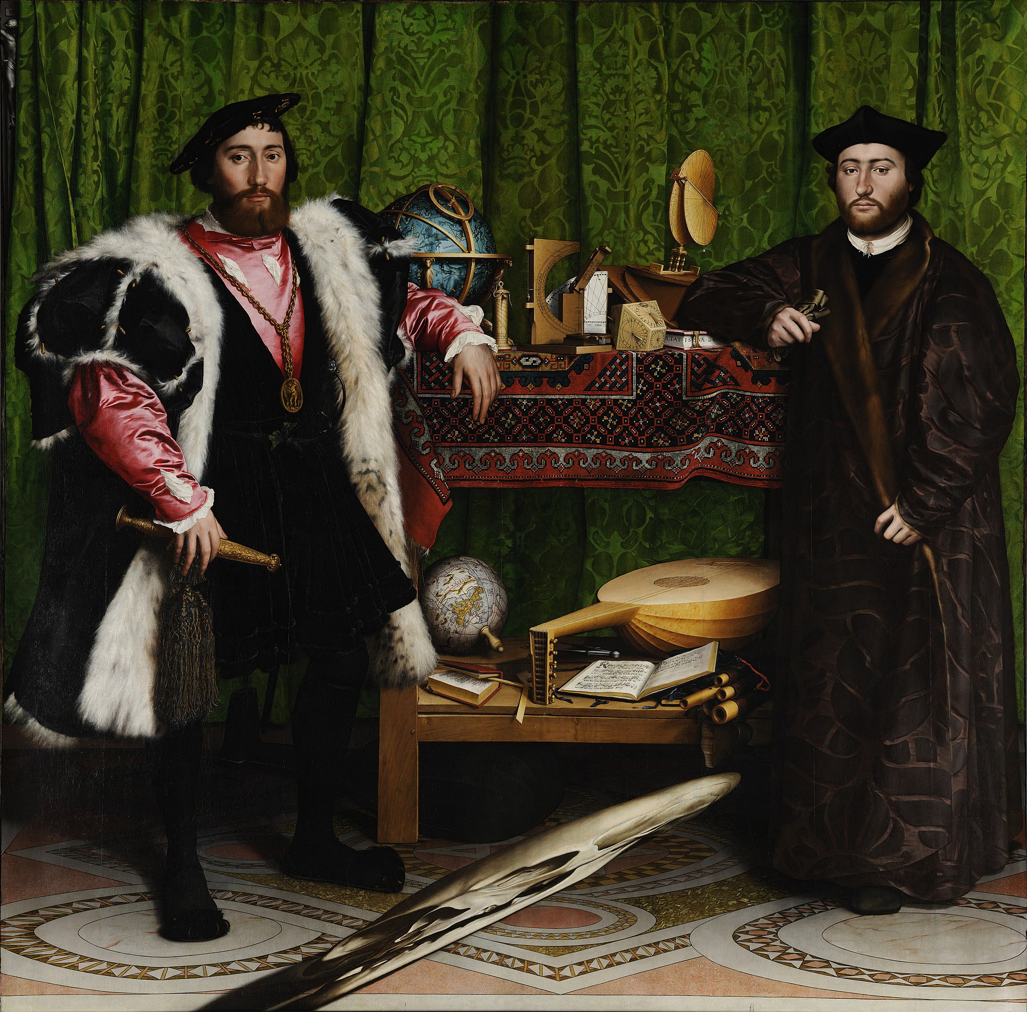 Two men stand beside a table displaying various scientific instruments and books. The man on the left wears opulent Renaissance attire, while the man on the right dresses in darker, simpler robes.