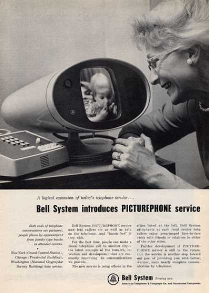 An elderly woman looks at a display screen on a Picturephone while holding a baby. The Picturephone shows a person on the other end. A headline reads: 