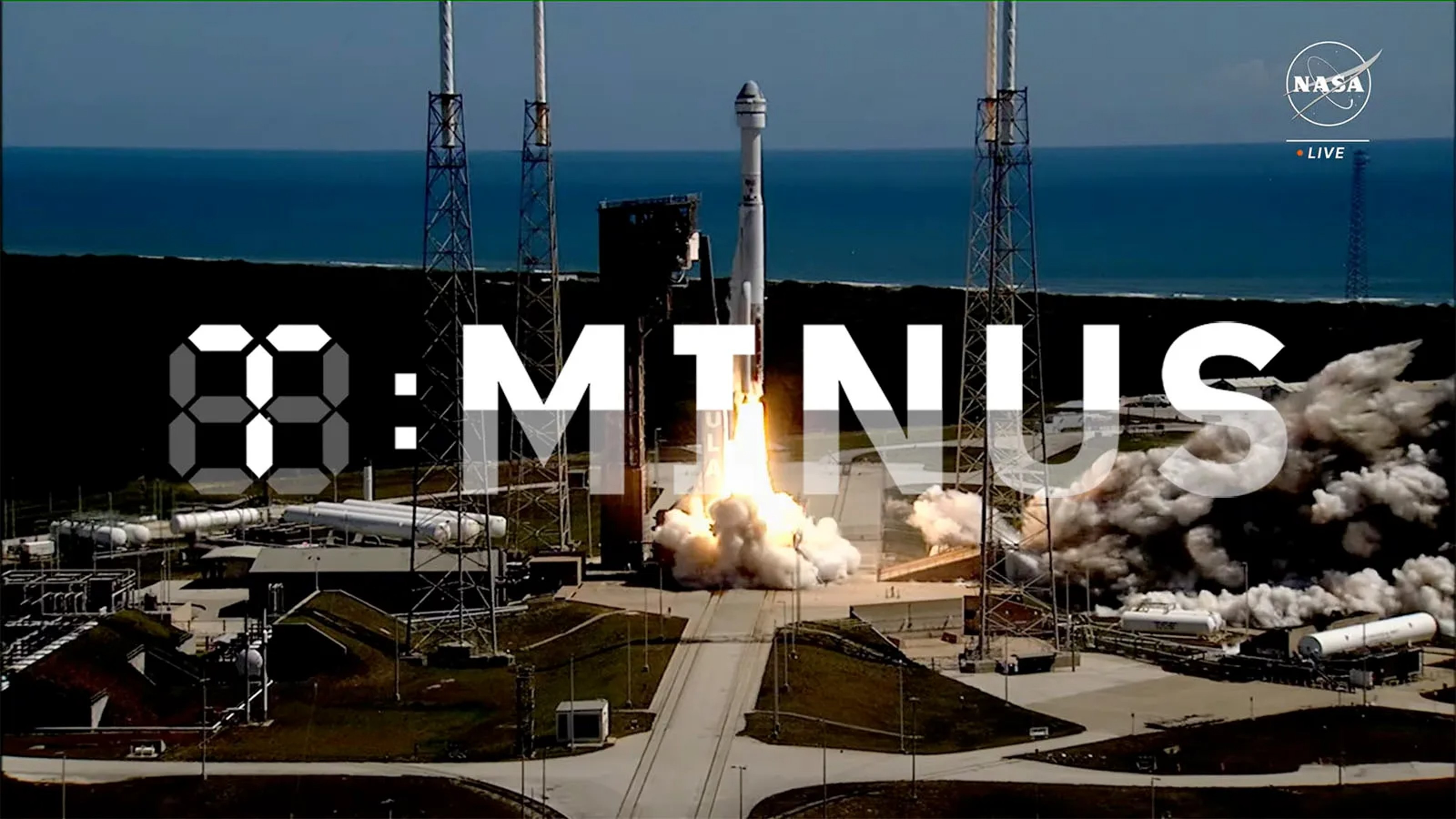 A rocket launches from a pad at a coastal space center with ocean in background. The word "TMNTUS" is overlaid in large letters.