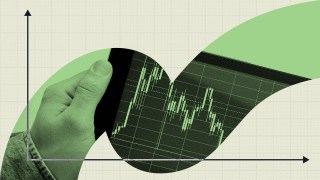 A hand holds a tablet displaying a fluctuating green stock market graph, capturing the attention of day traders with its dynamic curves and axis lines in the background.