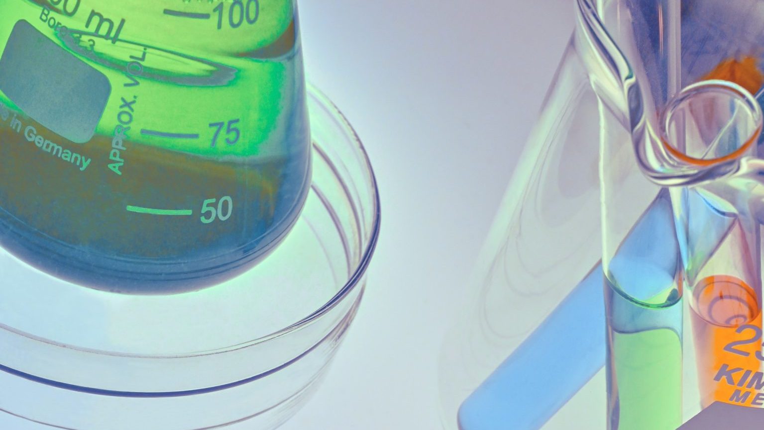 Laboratory glassware containing blue and green liquids, along with a petri dish holding a cannabis leaf, are arranged on a light background.