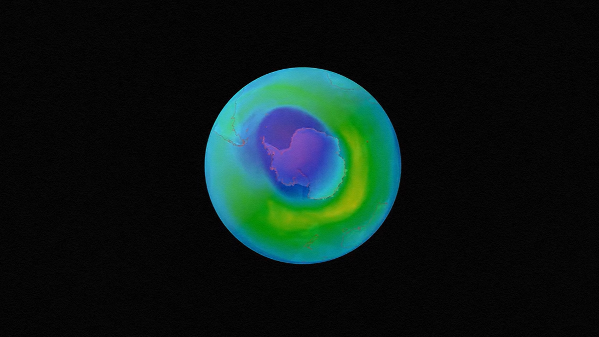 A visual representation of the hole in the ozone over Antarctica, depicted in varying colors to indicate different ozone concentration levels, against a black background.