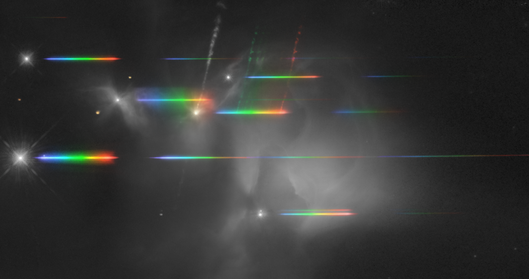 A grayscale image of space with several bright spots and horizontal rainbow-colored streaks scattered across the scene.