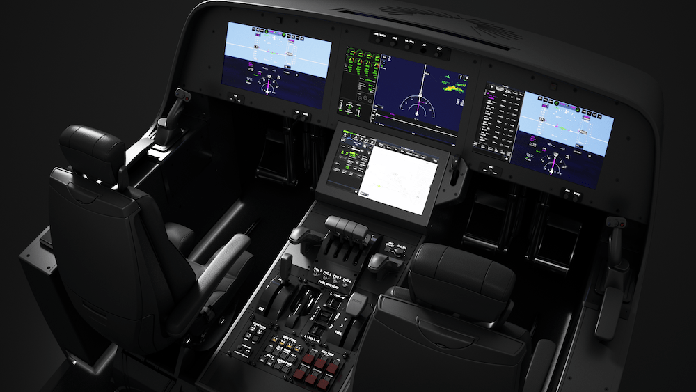 A detailed view of a modern cockpit featuring multiple digital screens, a control panel with numerous switches, and two pilot seats.