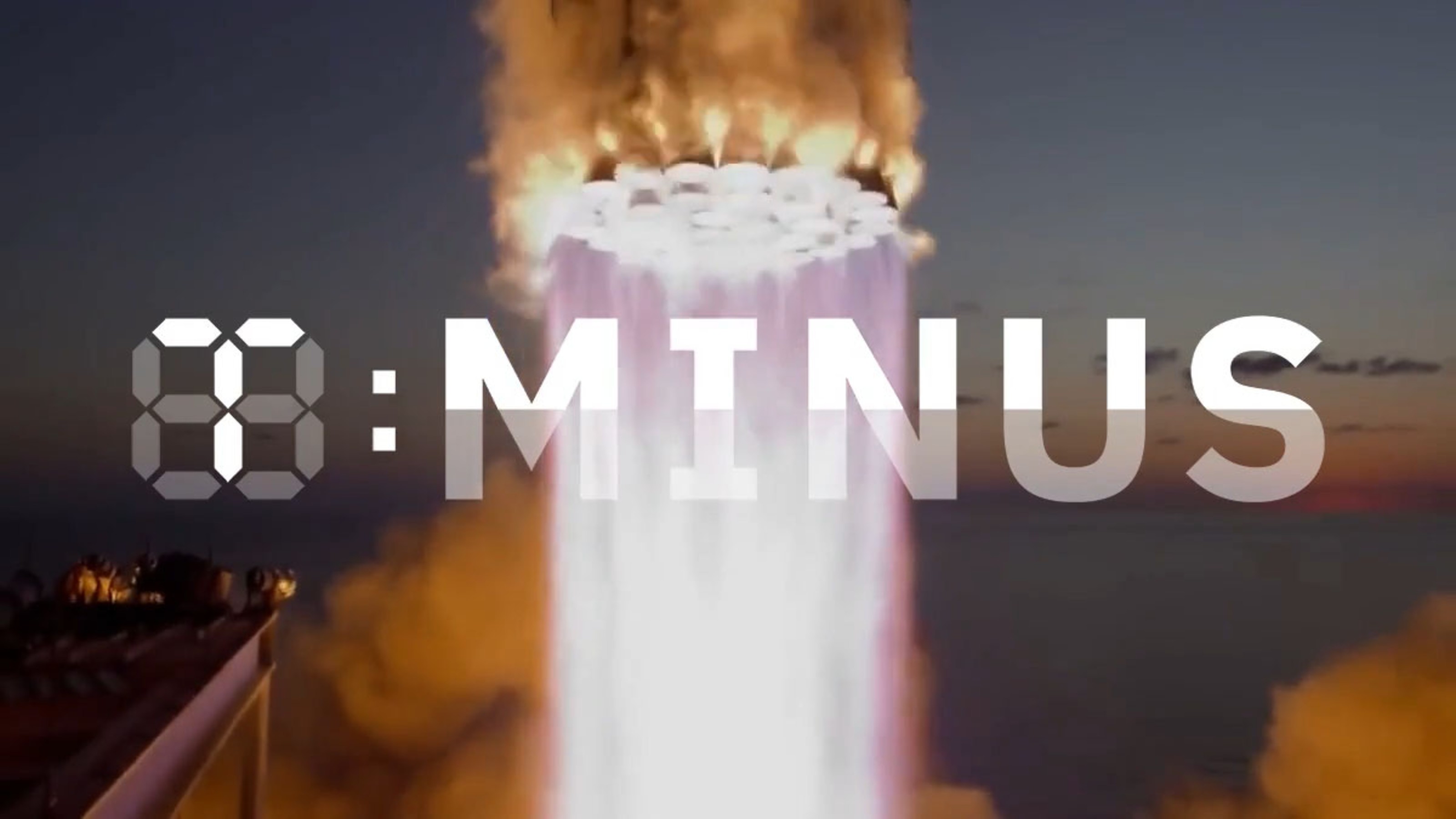 A rocket launches with flames visible at the bottom. The text "T-MINUS" is superimposed over the image.