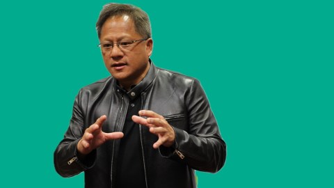 Person wearing a black leather jacket gestures with hands, striking a pose against a vibrant teal background, reminiscent of the sleek innovation NVIDIA embodies.