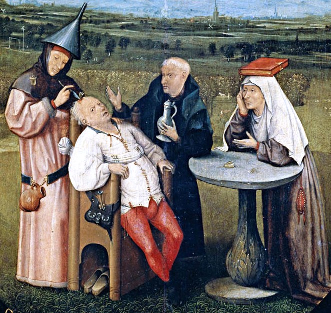 A medieval scene of three figures around a seated man. One person is performing a procedure on the man's head. The background depicts a landscape with buildings.