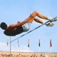 An athlete skillfully executes the Fosbury Flop, soaring gracefully in mid-air over the high jump bar, while colorful flags flutter and spectators watch in awe.