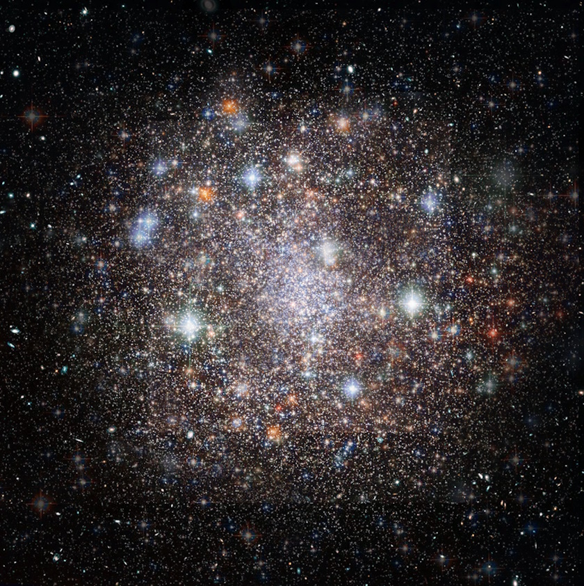 A dense cluster of bright stars and colorful galaxies, including a remarkable super star cluster, set against a dark background, showcasing a vibrant cosmic scene in space.