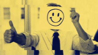 A person in a suit holds a paper with a smiley face over their head, giving the thumbs-up with the other hand—perhaps caught in the people-pleaser trap, masking true feelings for approval.