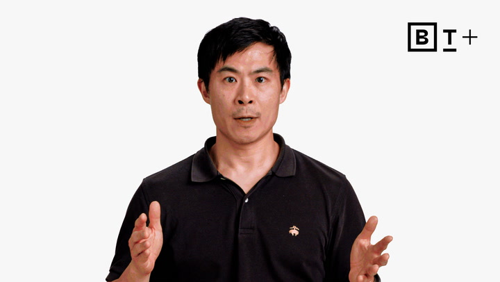 A man in a black polo shirt gestures with his hands while speaking. A logo with the letters "BT+" appears in the top right corner on a plain white background.