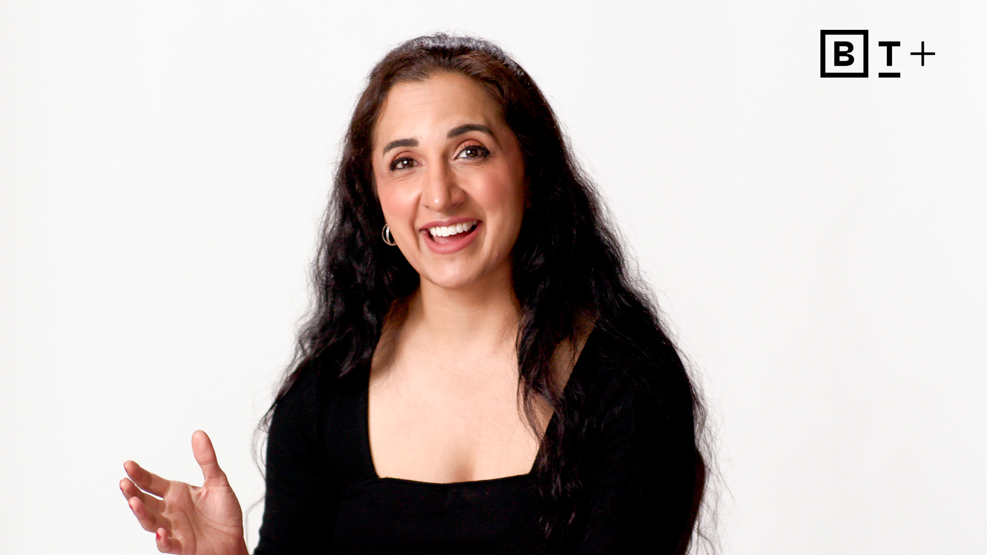 A woman with long hair smiling.